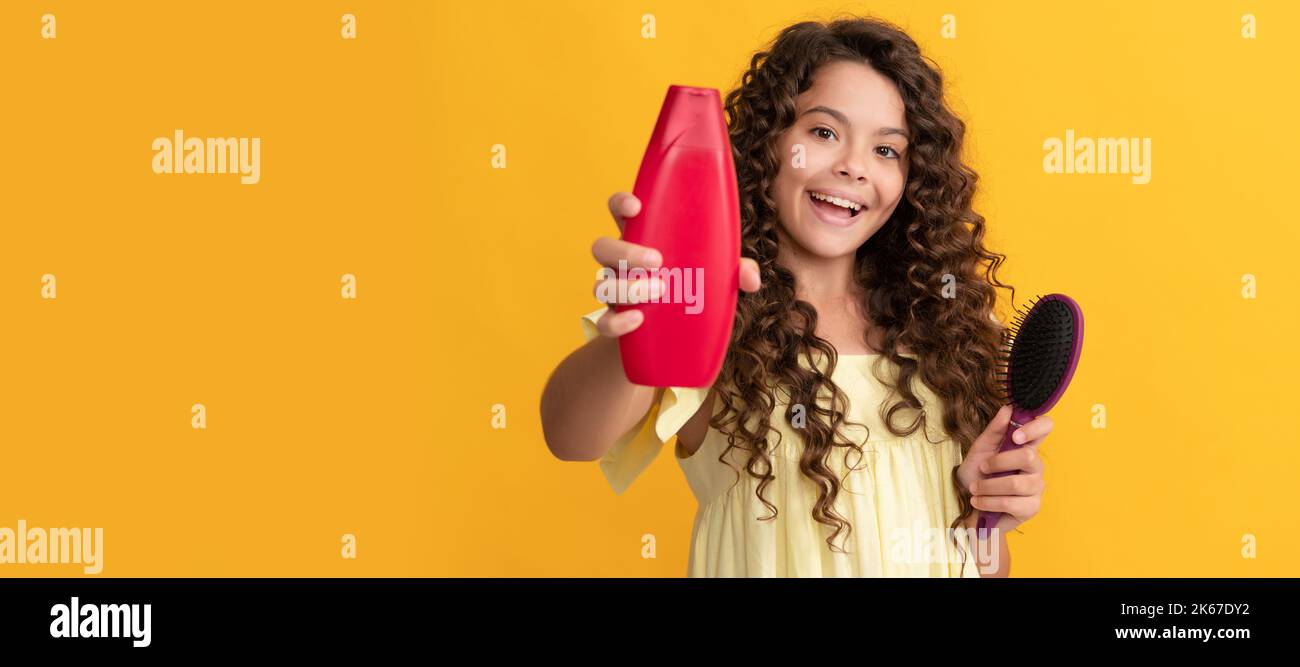 haircare and hair loss. selective focus. happy kid curly hair with comb