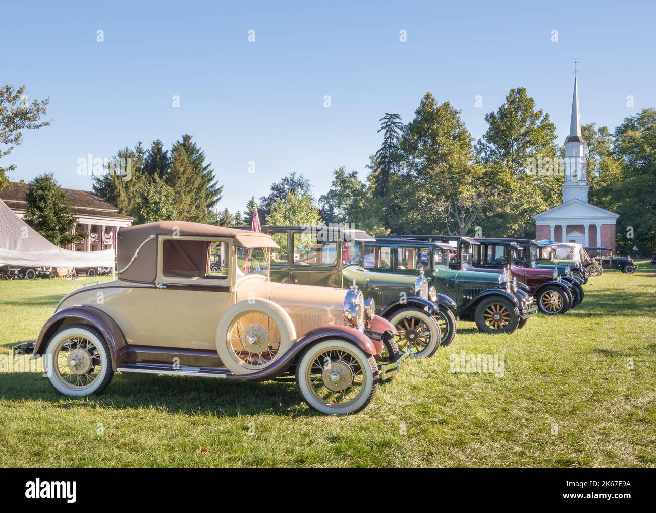 DEARBORN, MI/USA - SEPTEMBER 7, 2014: Eight antique cars, including a 1928 Ford Model A, Martha-Mary Chapel, Old Car Festival, Greenfield Village. Stock Photo