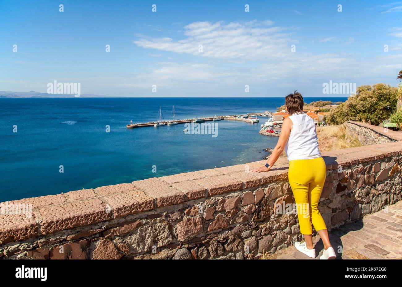 Woman  taking in the view  over the harbour at Molyvos on the Greek island of Lesbos Greece Stock Photo