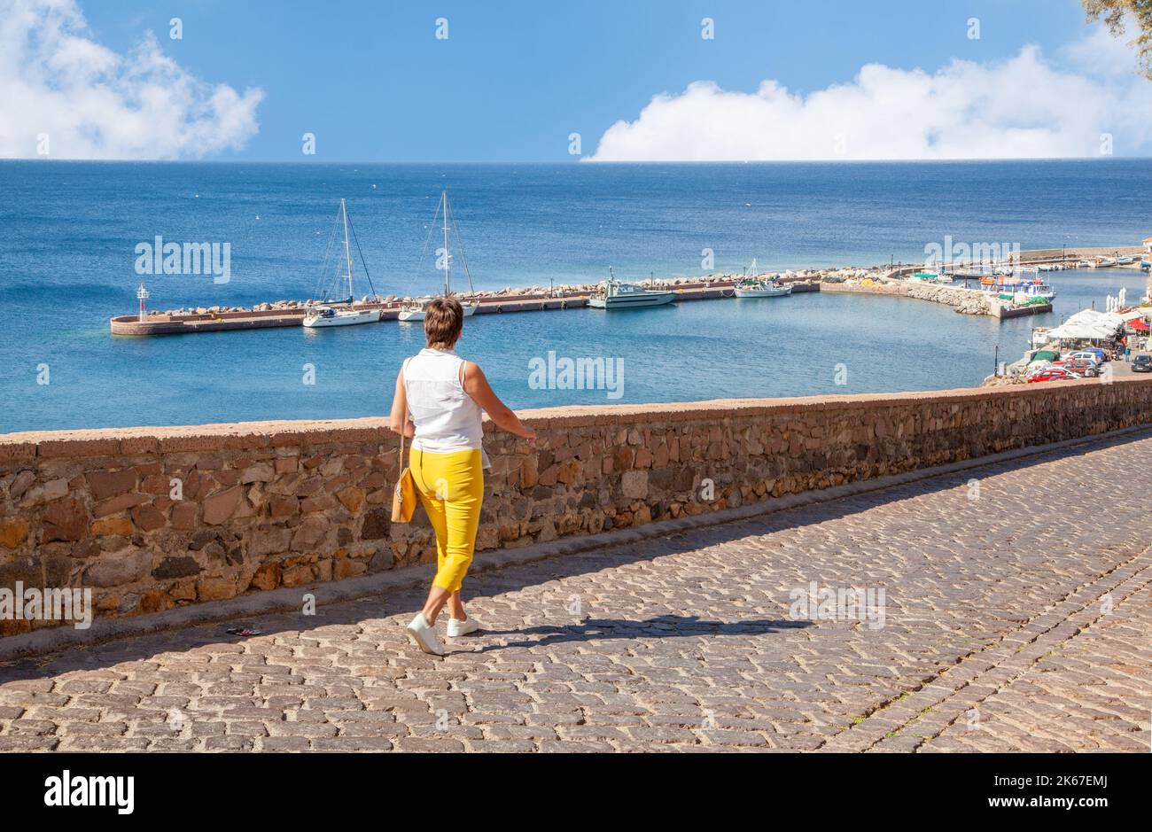 Woman  taking in the view  over the harbour at Molyvos on the Greek island of Lesbos Greece Stock Photo
