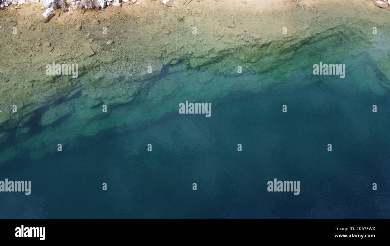 An aerial view of a rocky beach meeting the sea Stock Photo - Alamy