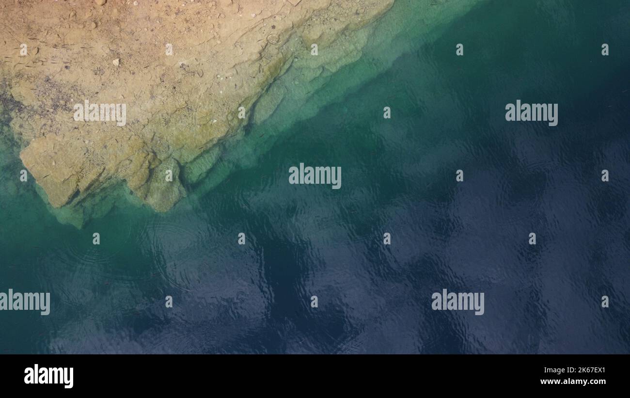 An aerial view of a rocky beach meeting the sea Stock Photo - Alamy