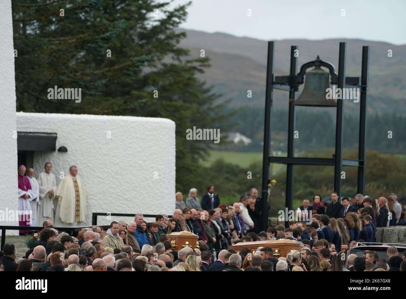 The coffins of James Monaghan and his mother Catherine O'Donnell are carried into St Michael's Church, Creeslough for their funeral mass. They both died following an explosion at Applegreen service station in the village of Creeslough in Co Donegal on Friday. Picture date: Wednesday October 12, 2022. Stock Photo