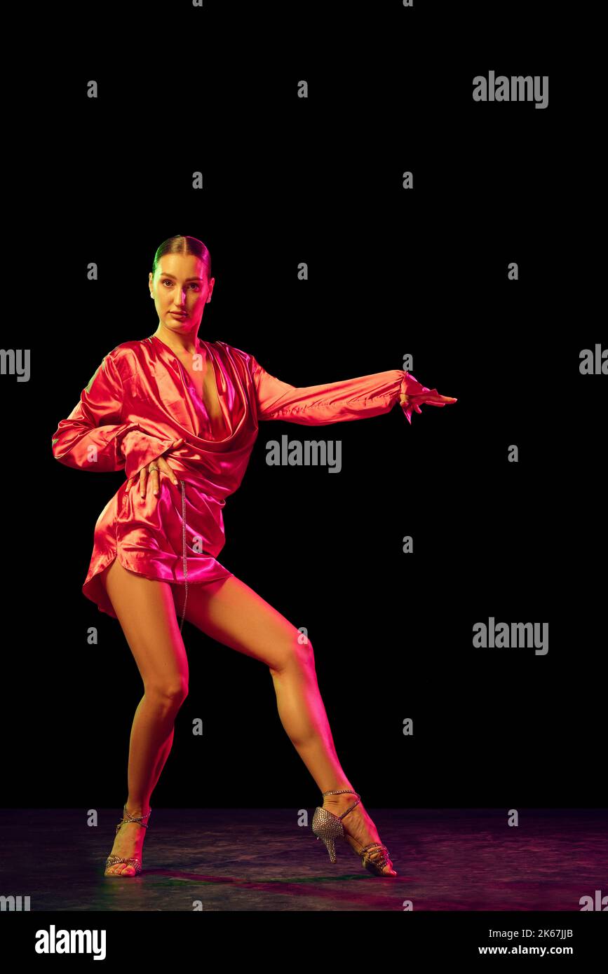 Solo. Portrait of young graceful flexible woman dancing ballroom dance