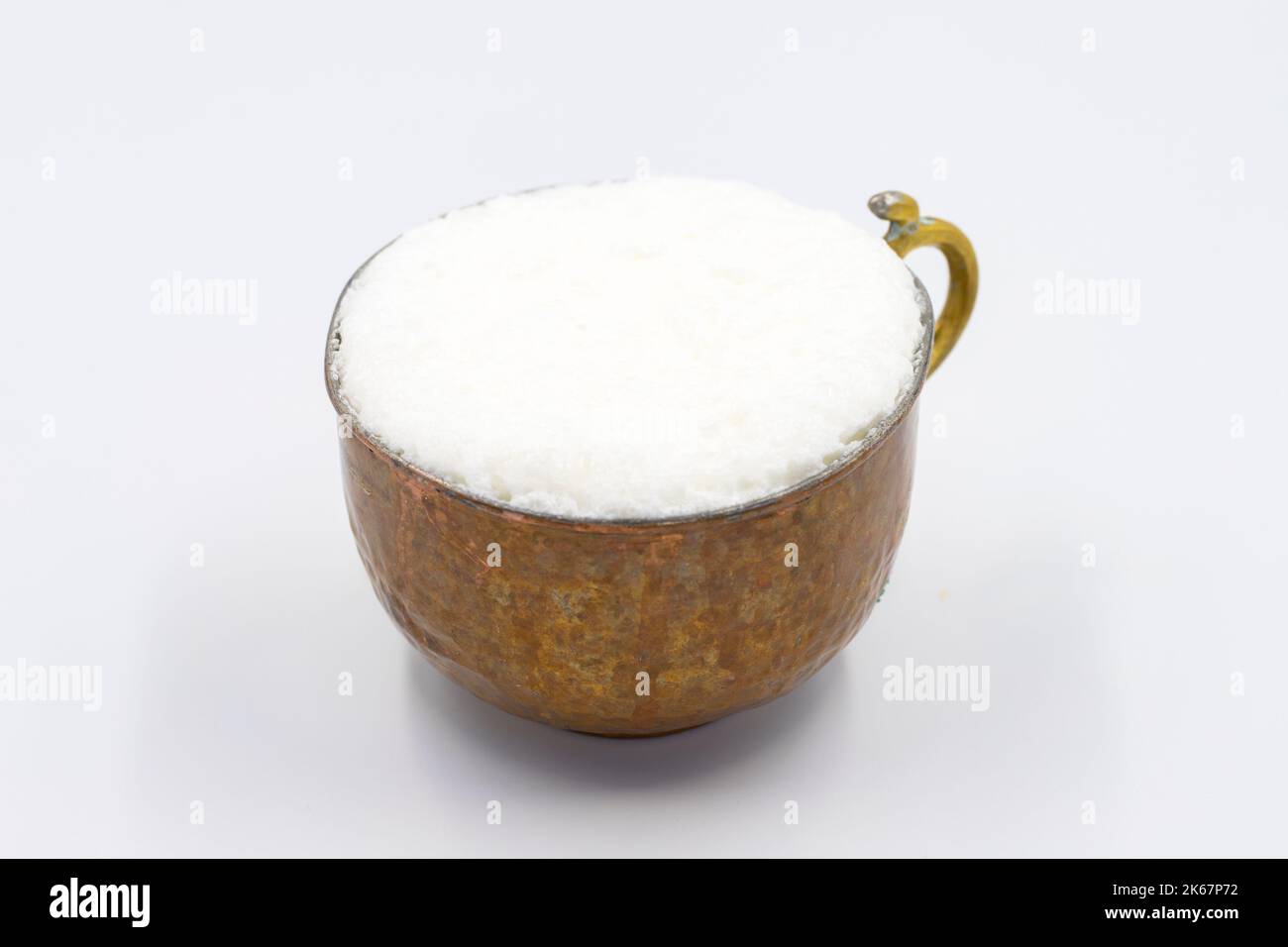 Sparkling buttermilk in a copper glass. Traditional Turkish food. Drink made with yogurt. close