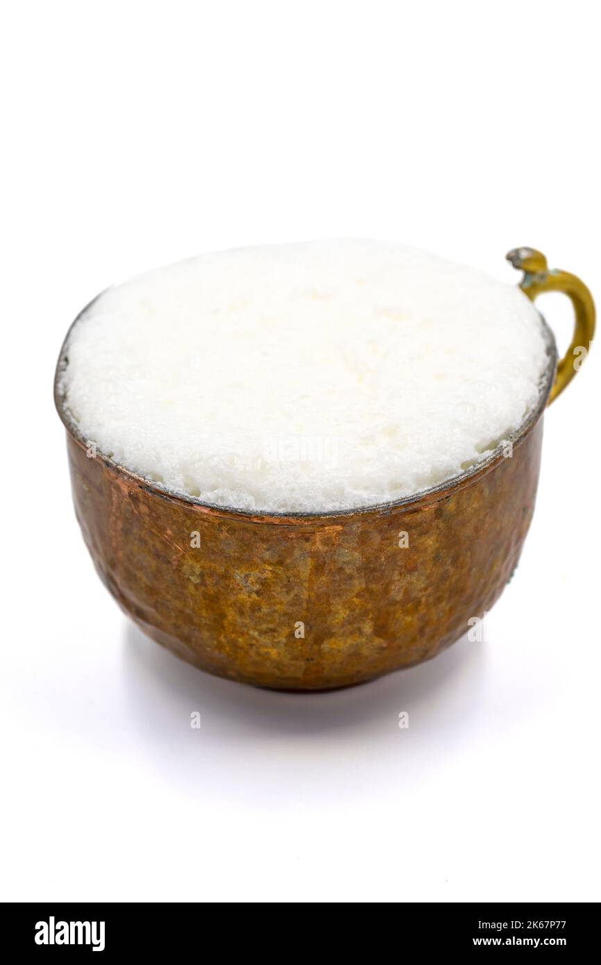 Sparkling buttermilk in a copper glass. Traditional Turkish food. Drink made with yogurt. close