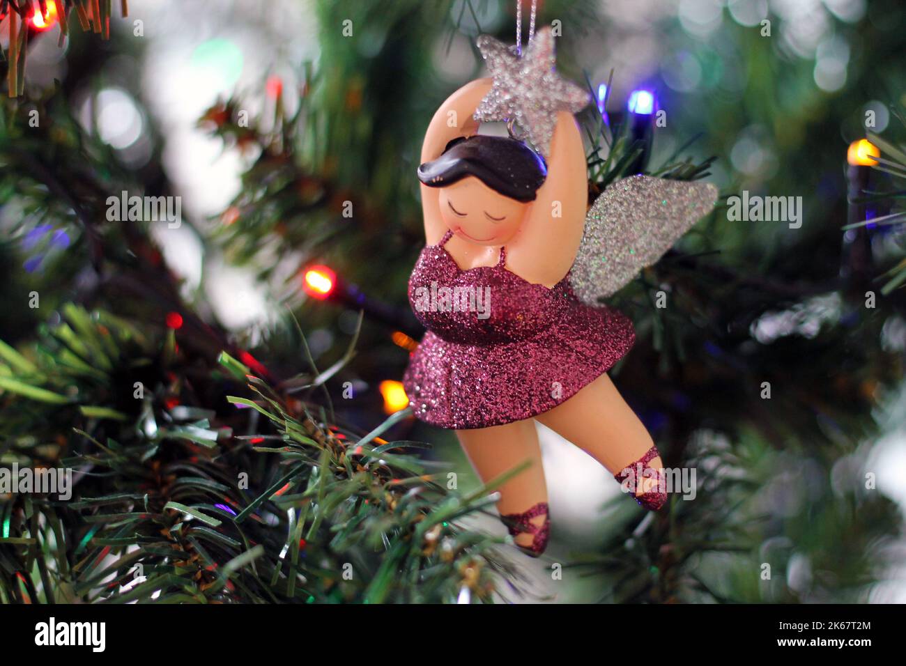 New christmas decorations in the form of a fat ballerina. Christmas toy hanging on the Christmas tree close-up. Stock Photo