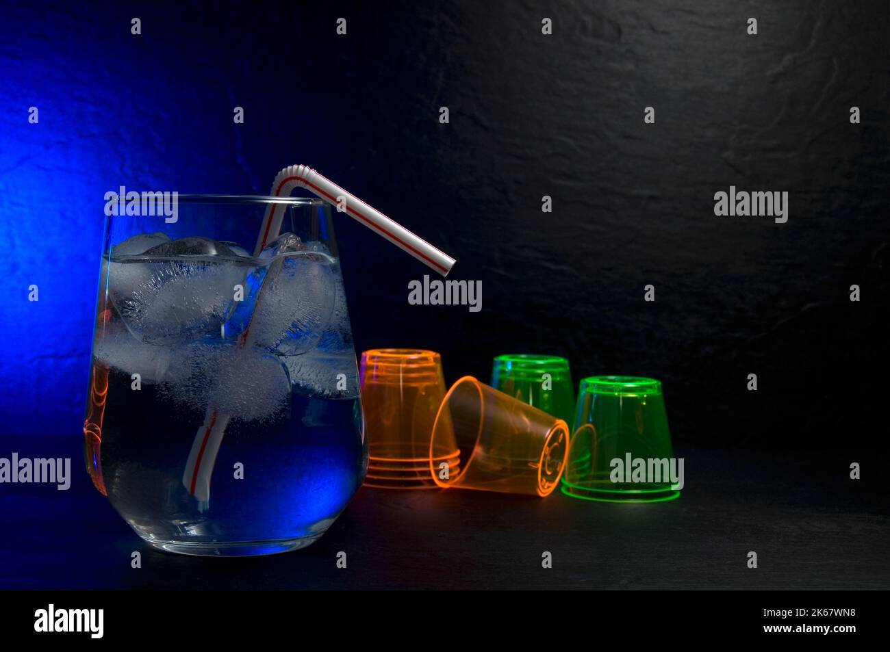 Beautiful Fancy Cocktail Drink in a Glass with Blue Light and Shooter