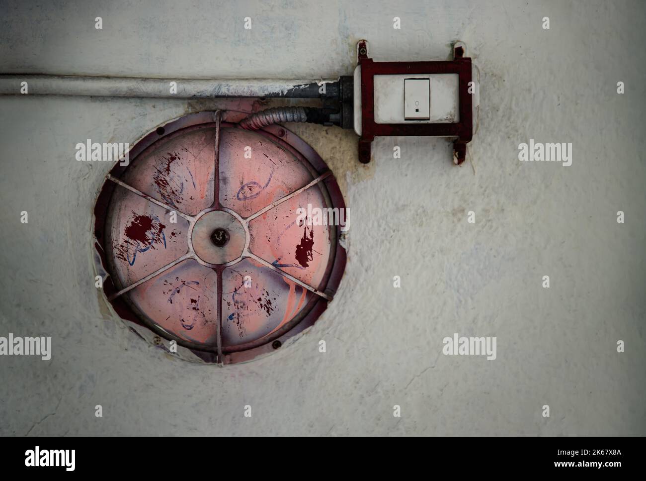 Old and dirty Red fire alarm bell and Electrical wires on white