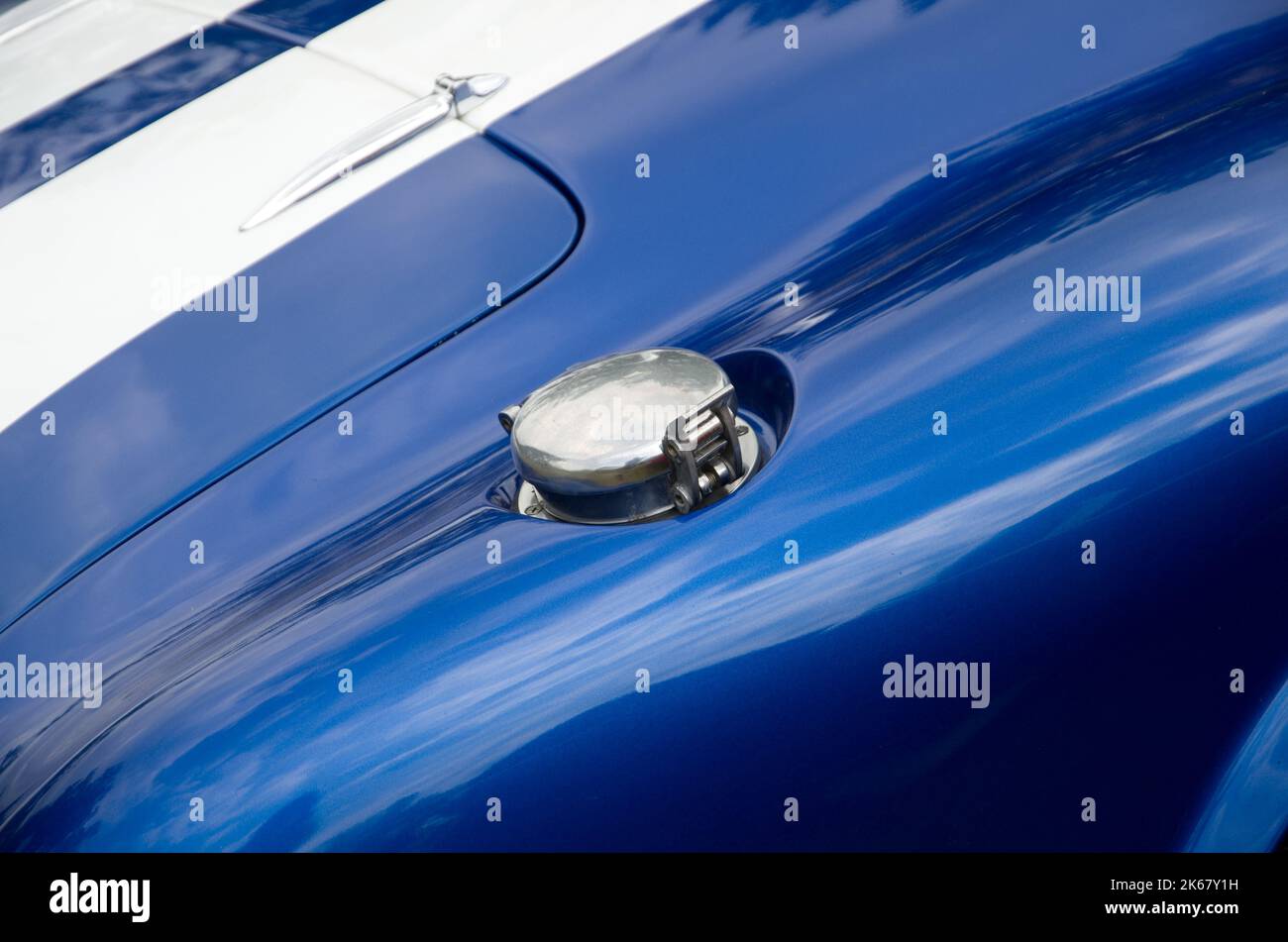 Chromed Gas Cap on a White and Blue Sport Car Horizontal Stock Photo