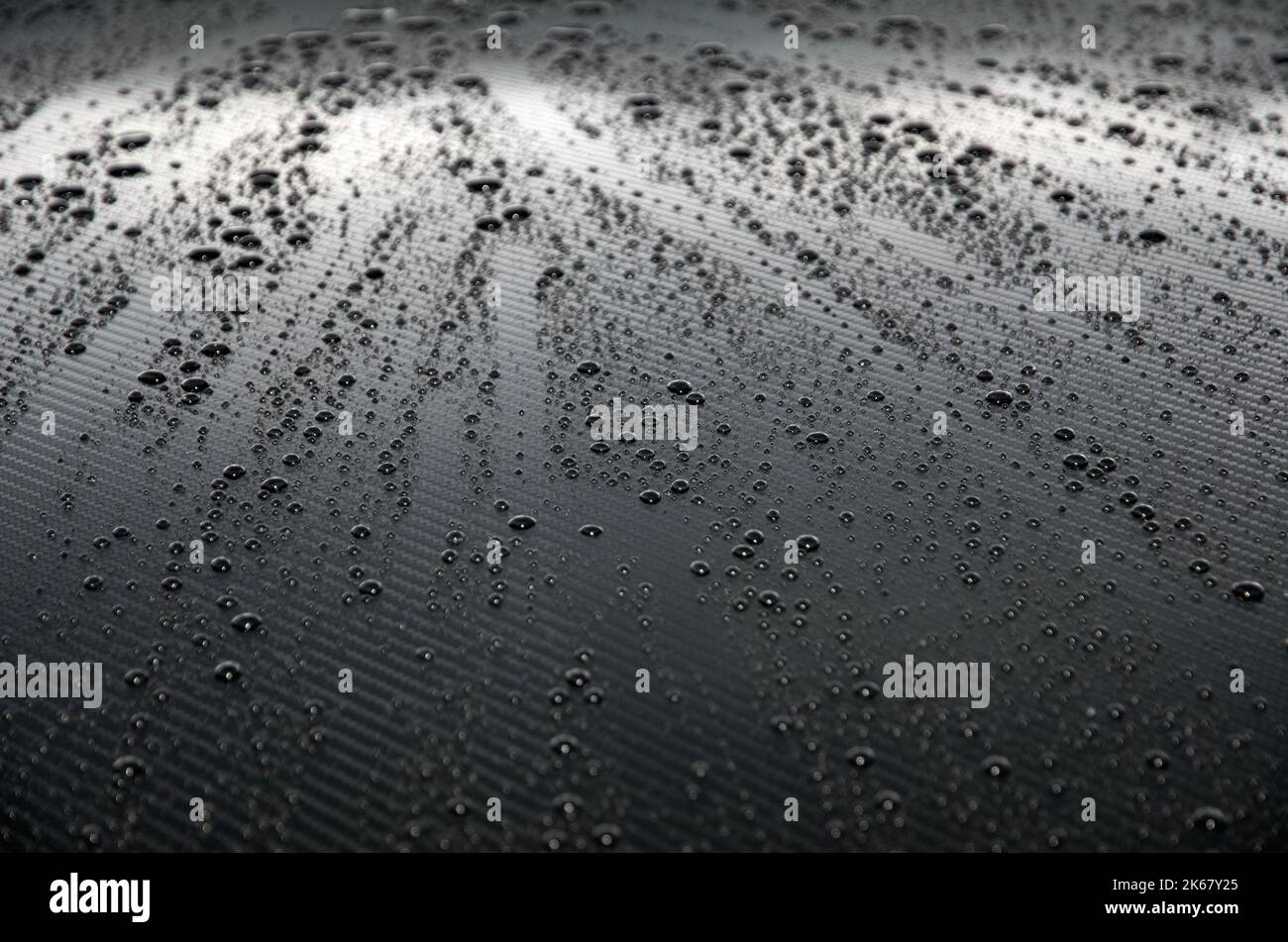 Rain Water Droplets on Graphite Automobile Hood Horizontal Stock Photo