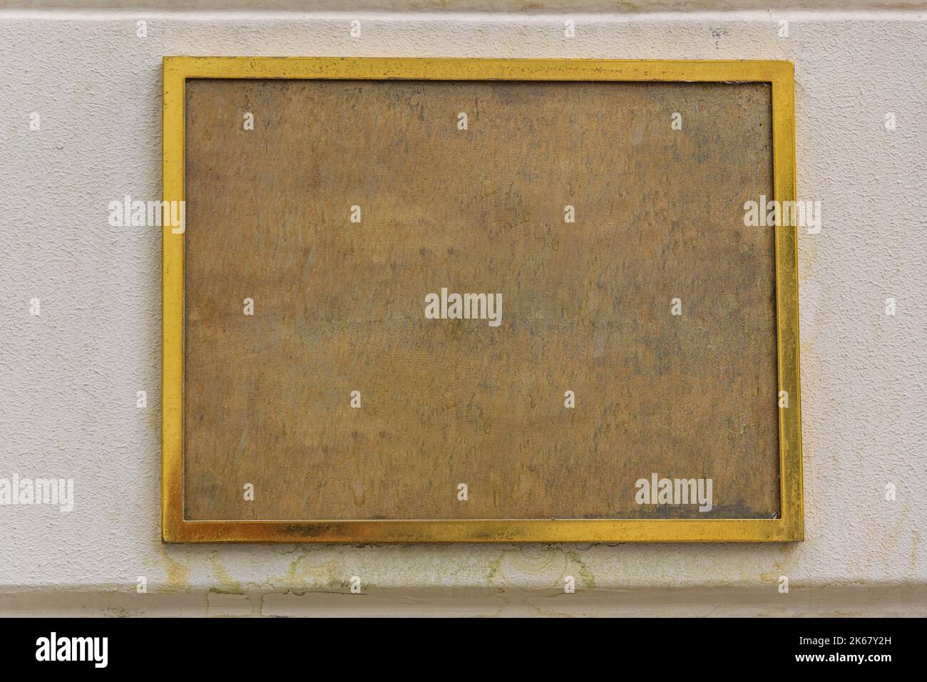 Weathered Brass Plaque Old Golden Frame at Building Wall Stock Photo