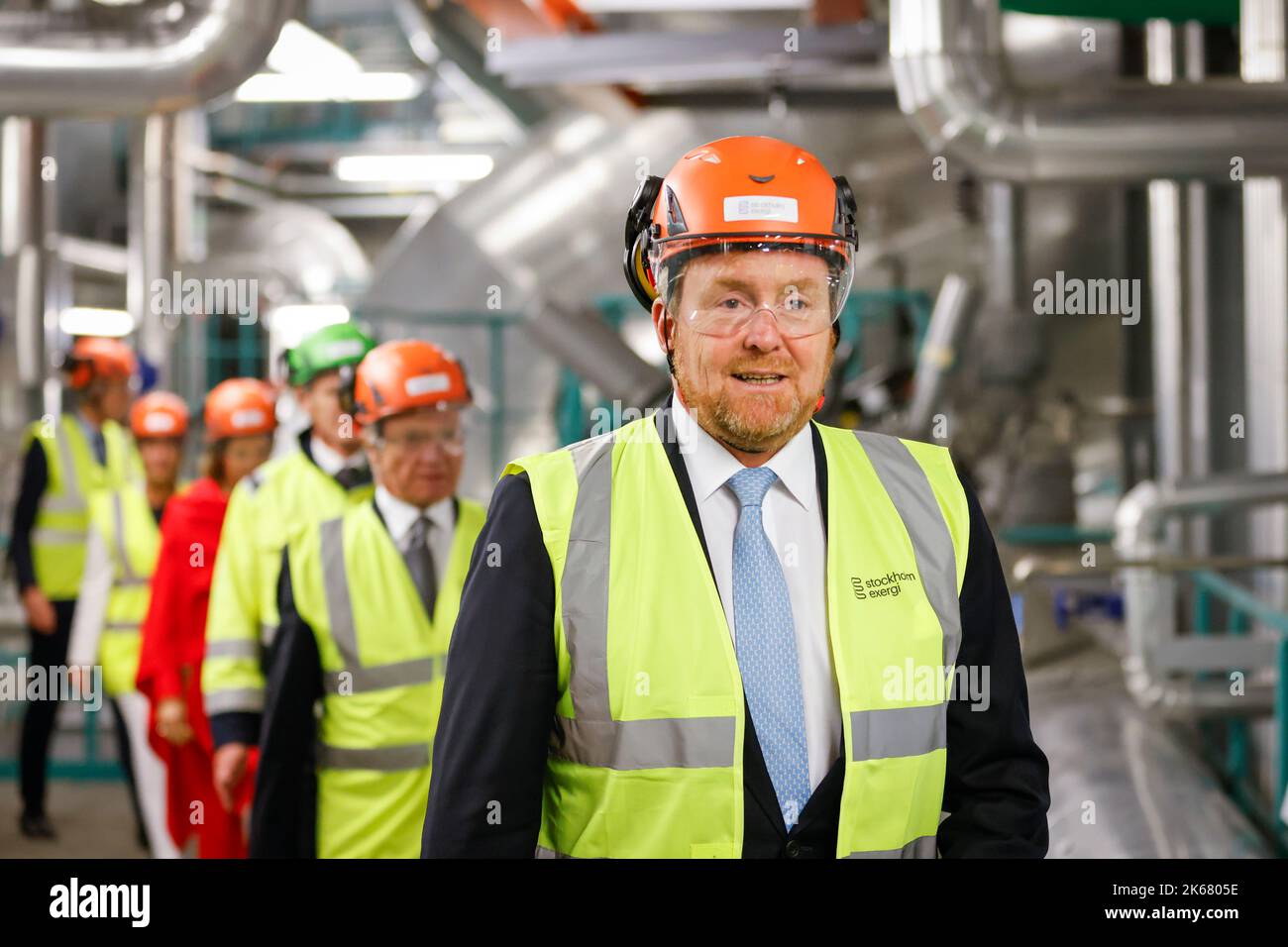 King Willem-Alexander wearing a helmet while visiting Stockholm Exergi ...