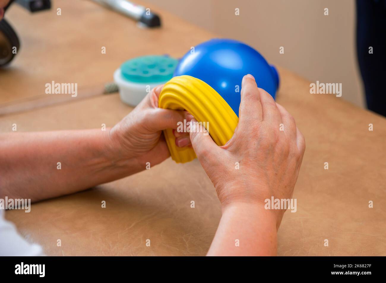 Close-up of male physiotherapist massaging the leg of patient in a physio room. Stock Photo