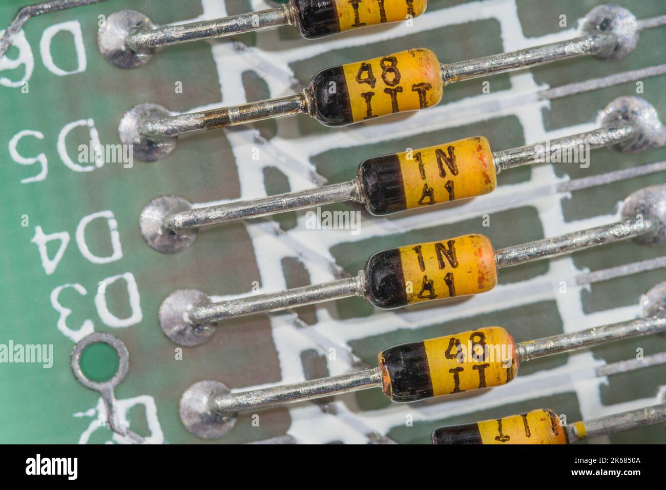 Row of diodes on Series 2, 16k, Sinclair ZX Spectrum home computer. Looks as if these are possibly yellow glass Zener diodes but unable to verify. Stock Photo