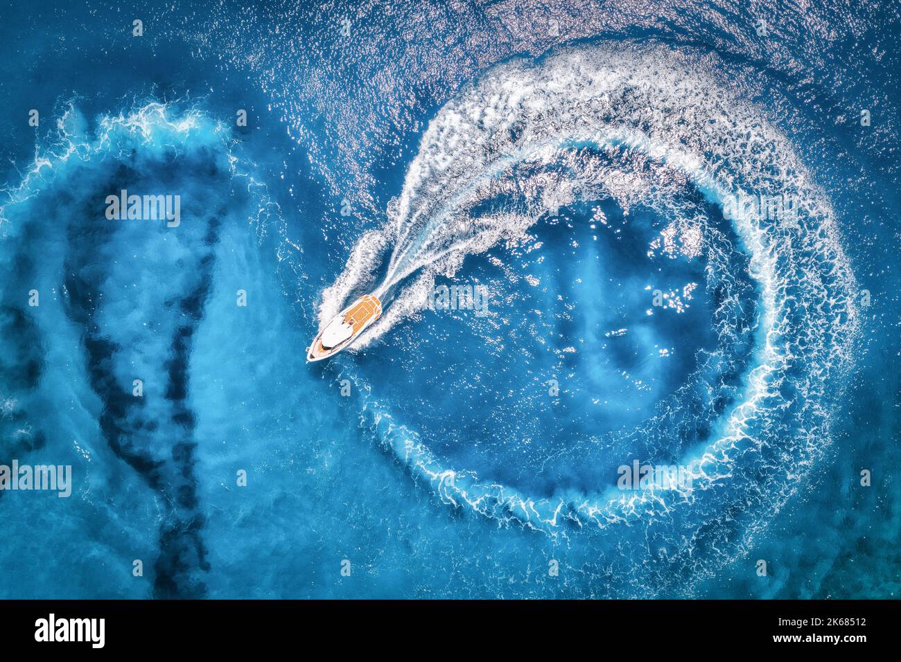 Aerial view of the speed boat in transparent blue water at sunset Stock ...