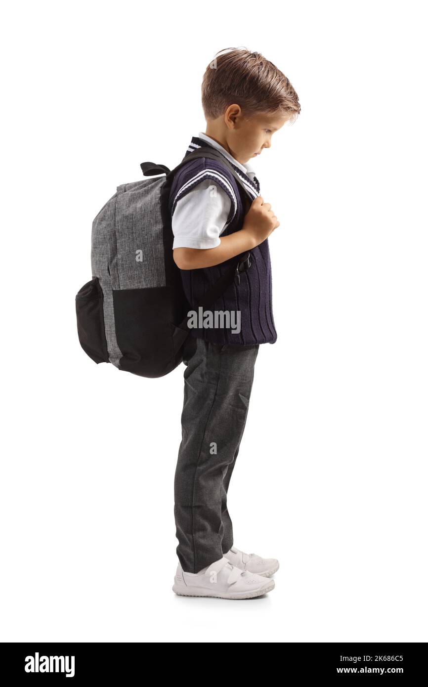 Full length profile shot of a sad boy in a school uniform isolated on white background Stock Photo