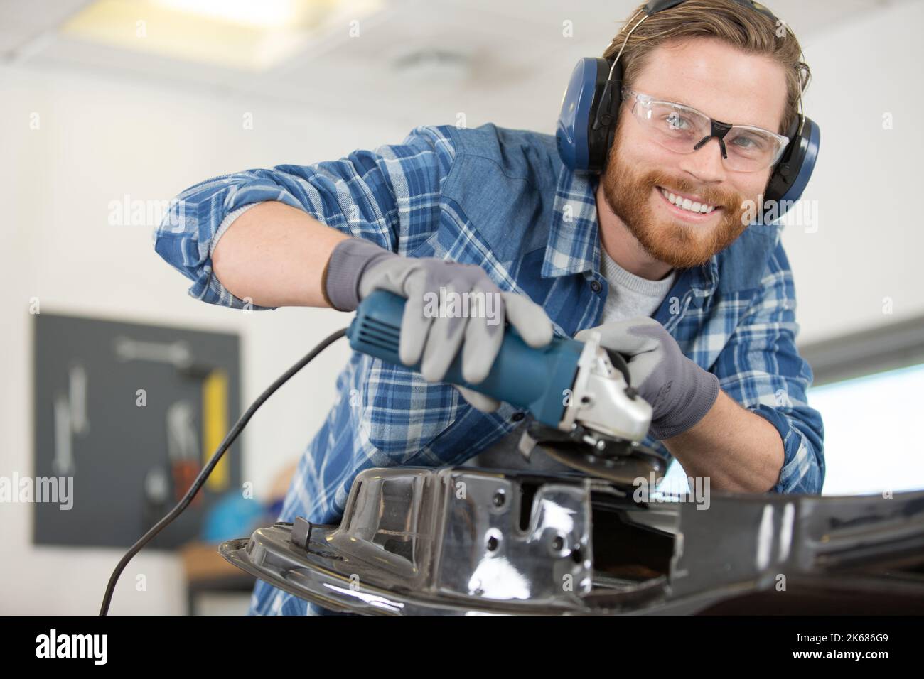 male mechanic using an angle grinder Stock Photo