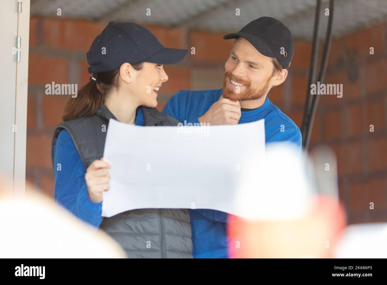 female engineer or architect checking interior building with construction worker Stock Photo