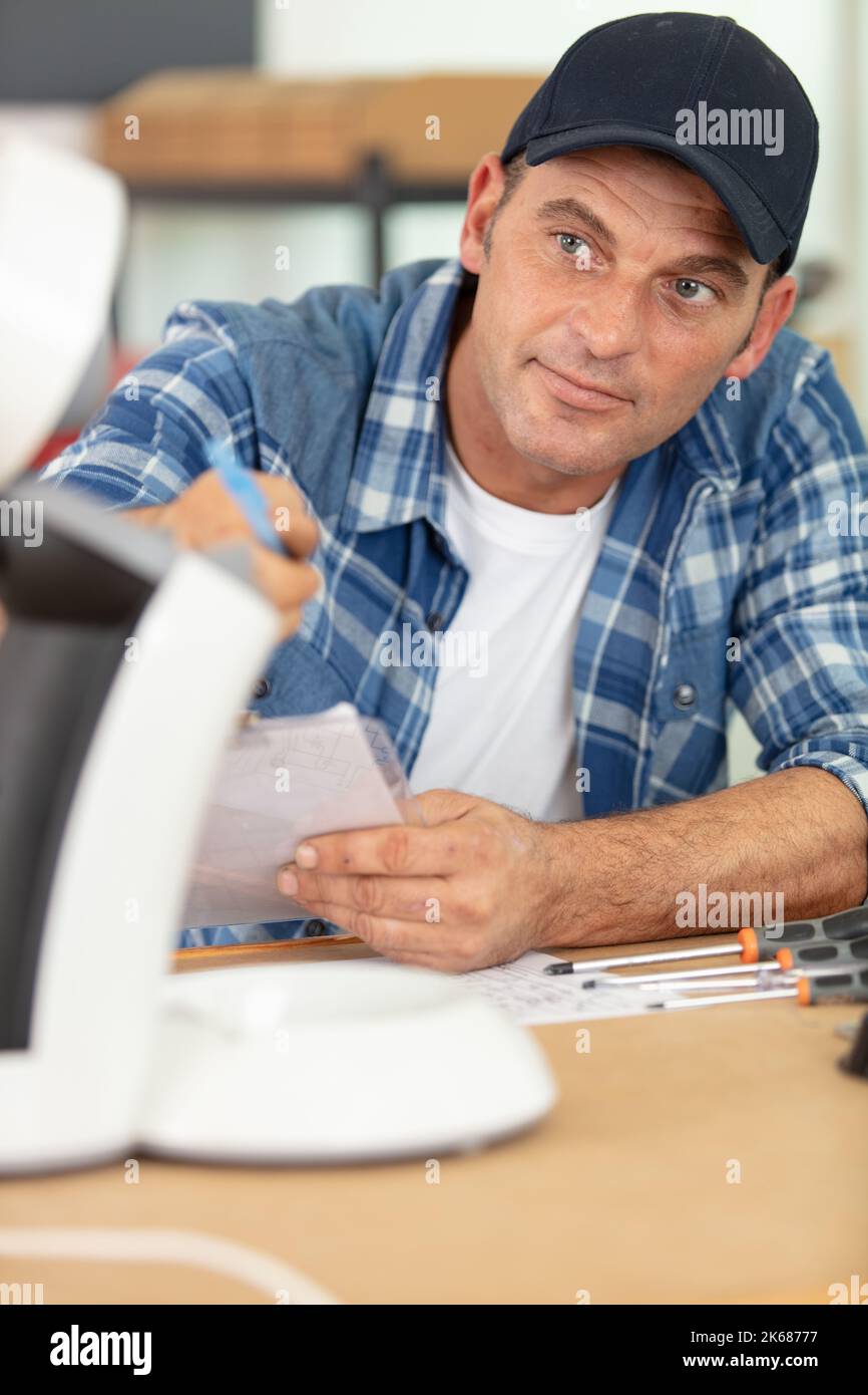 professional young worker fixing coffee machine Stock Photo