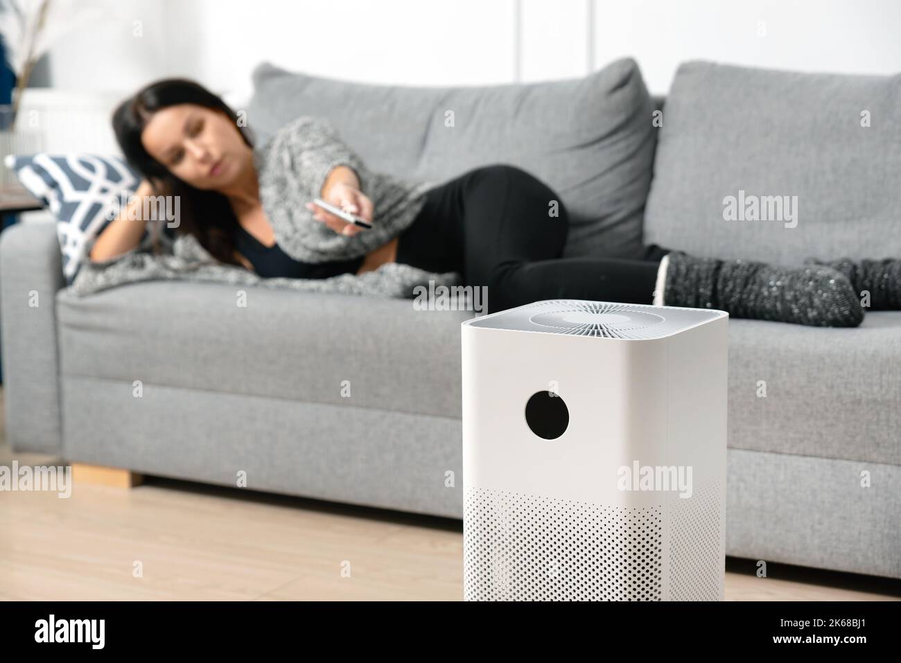 Woman using air purifier, PM 2.5 dust filter, clean and health air Stock Photo