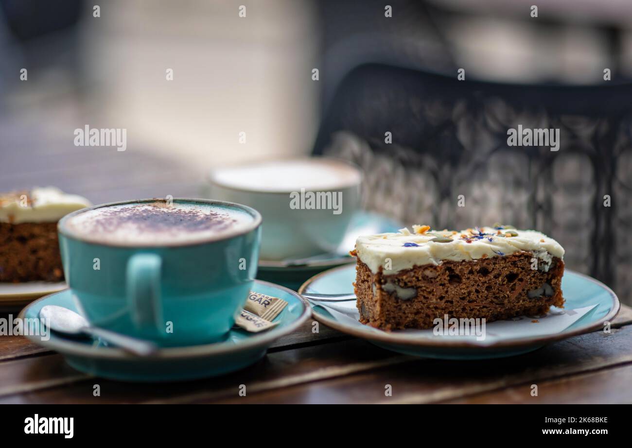 Coffee and Carrot cake for two on a table outside a café in St Ives Stock Photo