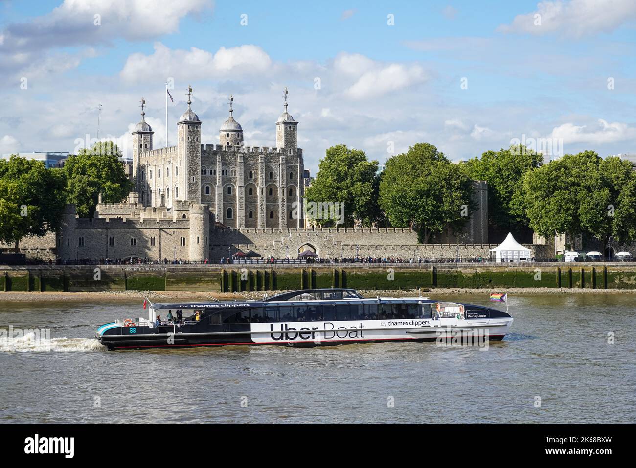 Thames clipper, Uber Boat passing the Tower of London on the River Thames,  London England United Kingdom UK Stock Photo - Alamy