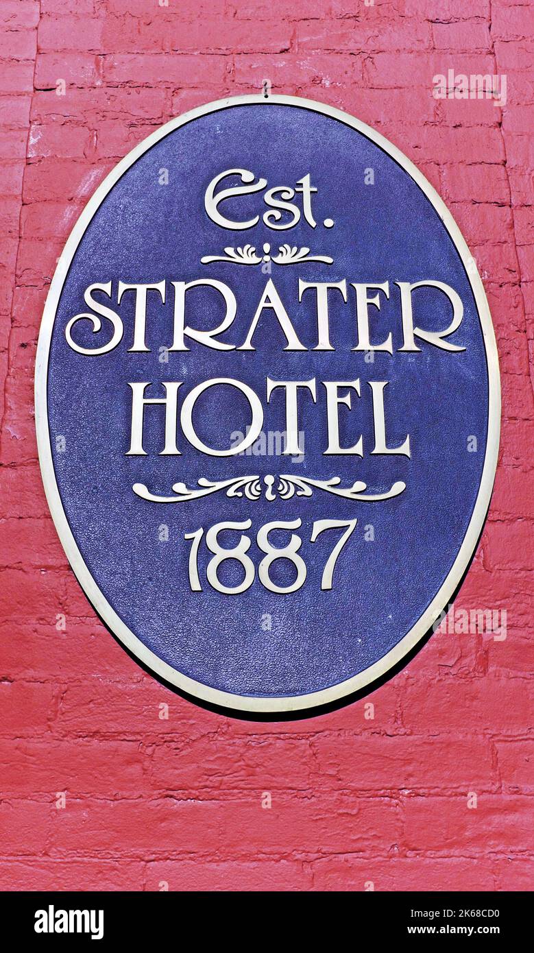 The iconic red brick Strater Hotel in Durango, Colorado plaque sits on its exterior wall near the Main Avenue entrance establishing its start in 1887. Stock Photo