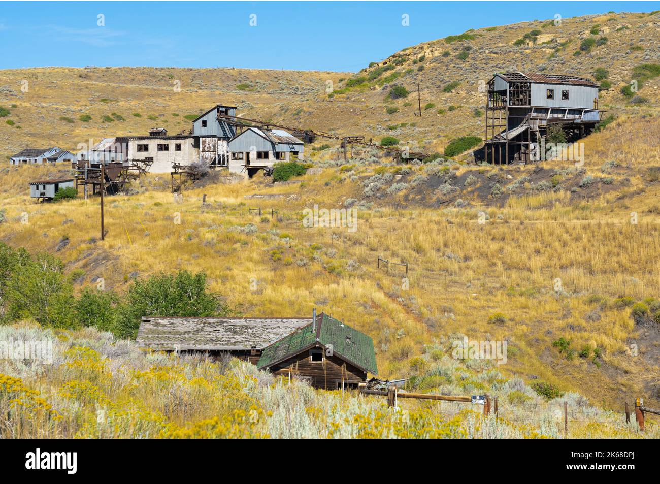 Old abandoned coal mine out buildings on hills in Montana between