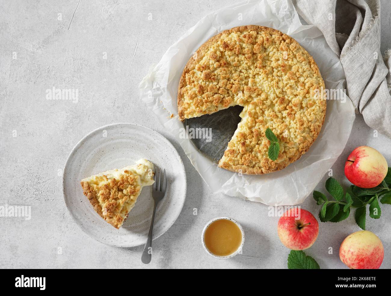 Traditional Homemade Apple Pie With Creamy Custard with a cutting piece on thre plate, top view, copy space Stock Photo