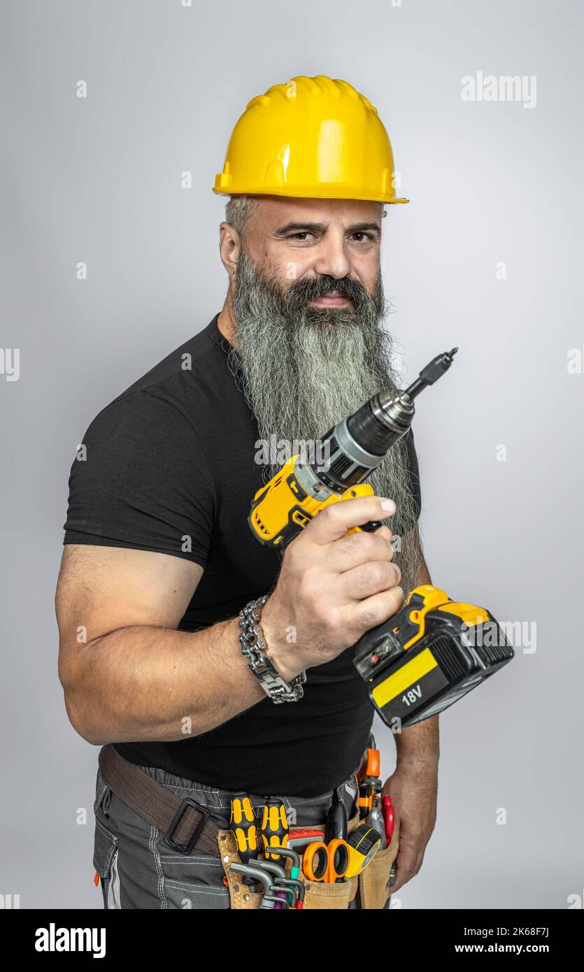 handyman with electric screwdriver studio shot Stock Photo Alamy