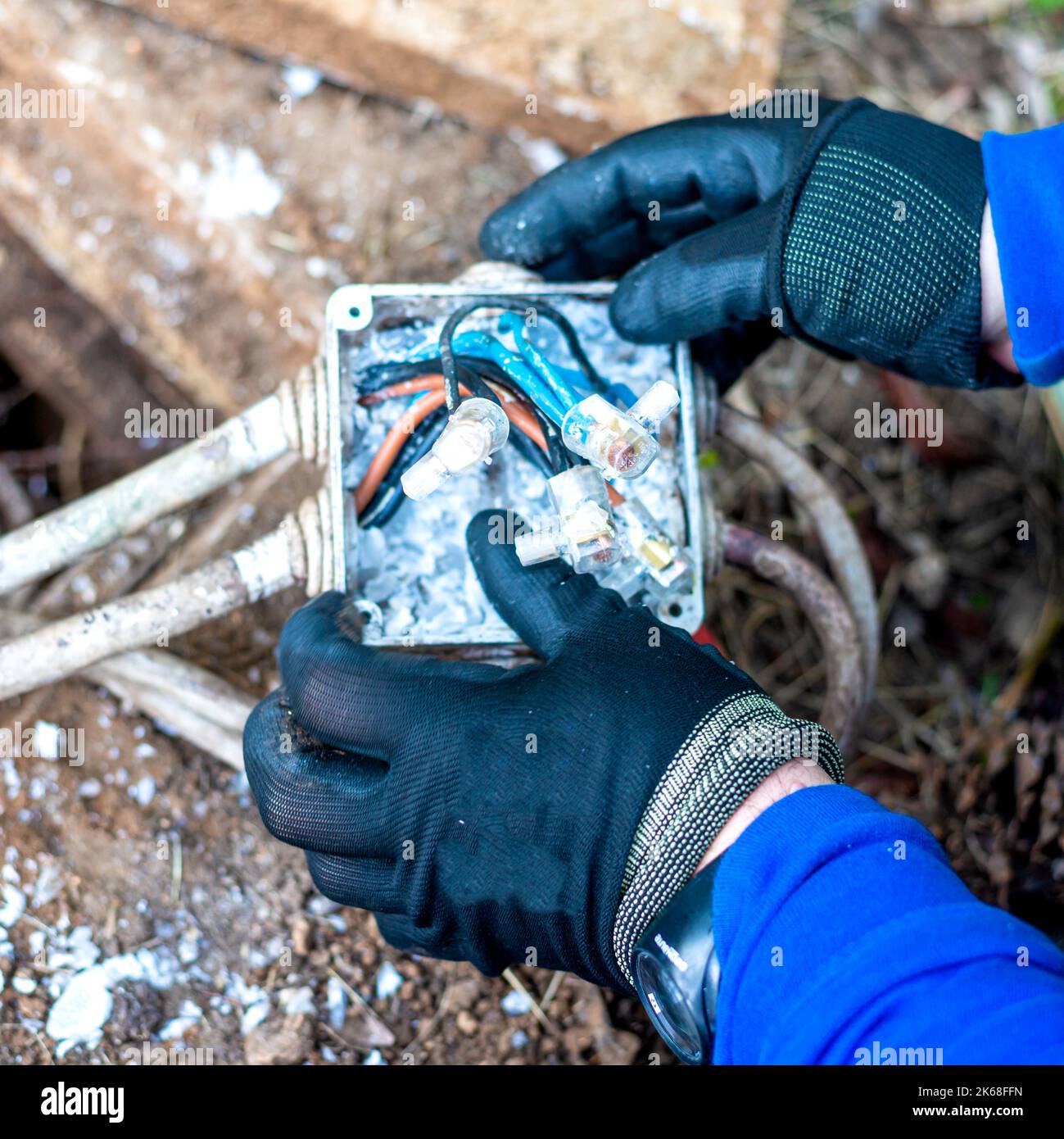 Worker inspecting the junction box of a public lighting line. Electric