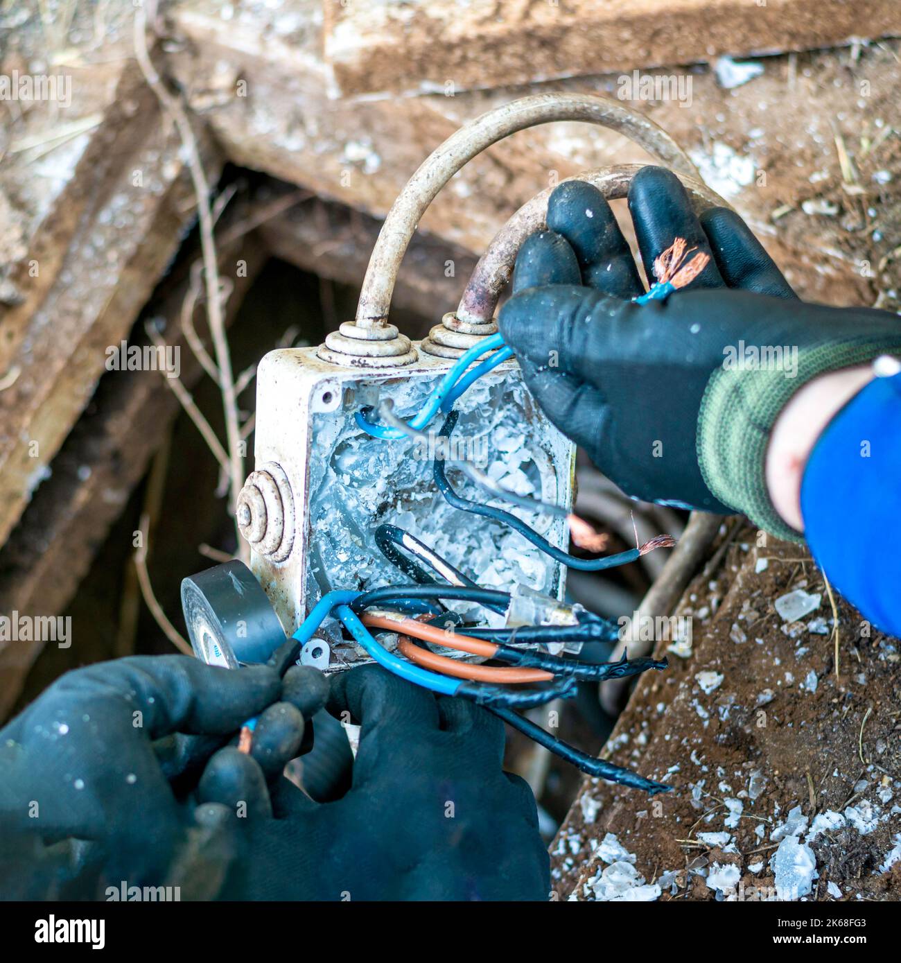 Worker inspecting the junction box of a public lighting line. Electric