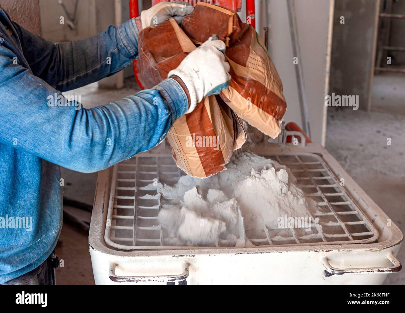 bag of premixed mortar into a cochlea mixer Stock Photo Alamy