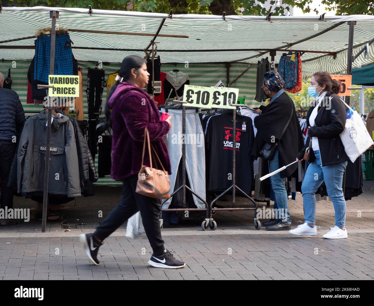 Shoppers in Walthamstow high street, London, United Kingdom, with pound sterling signs with prices Stock Photo