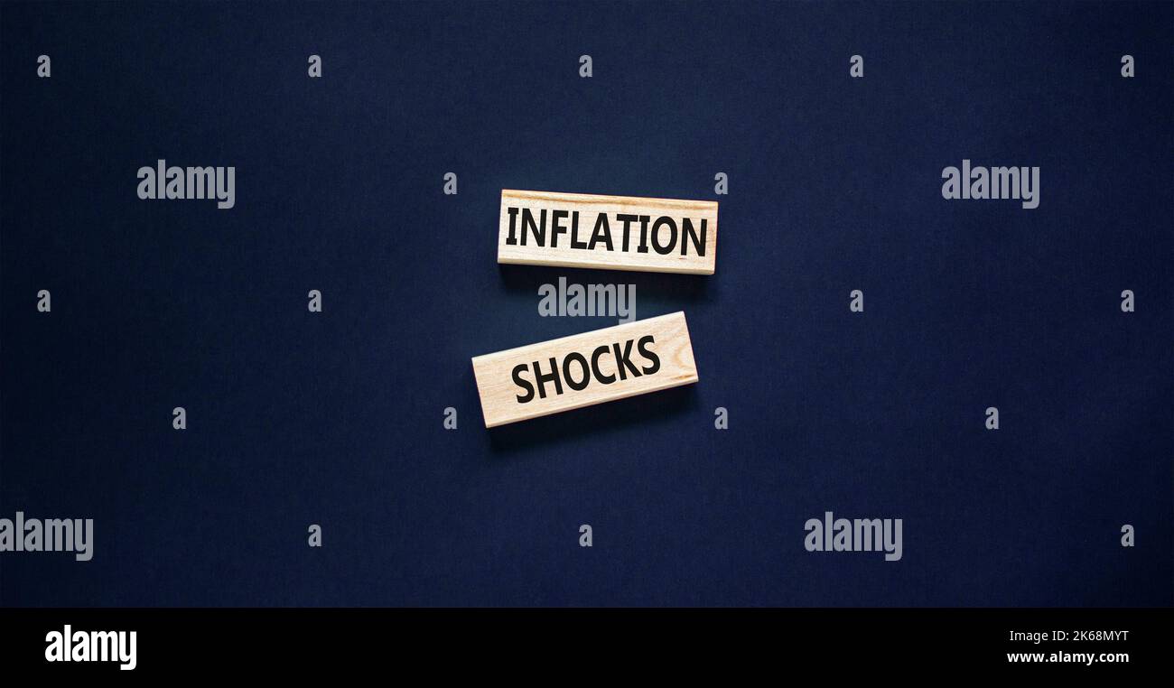 Inflation shocks symbol. Concept words Inflation shocks on wooden blocks. Beautiful black table black background. Business inflation shocks concept. C Stock Photo