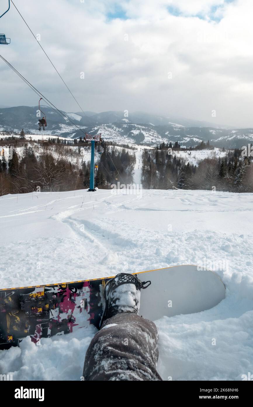 snowboarder sitting on the ski slope Stock Photo