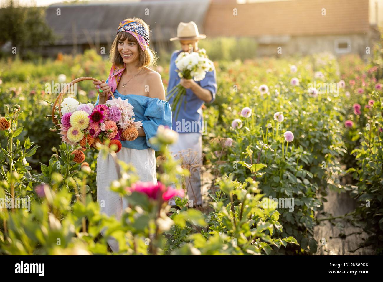 Man and woman pick up flowers at farm outdoors Stock Photo Alamy