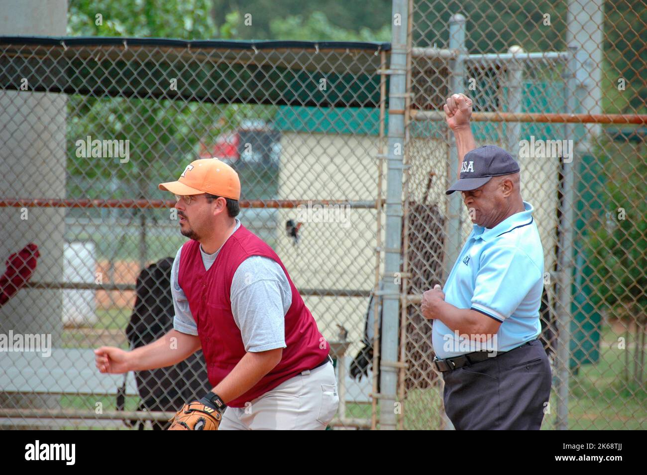 black male softball umpires for ASA in the US during games making calls