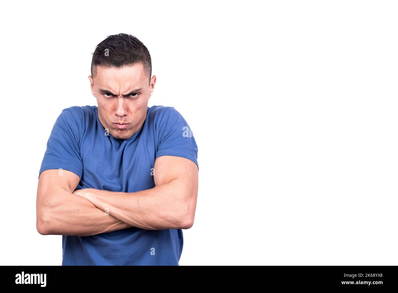 Man with crossed arms and angry scowl Stock Photo