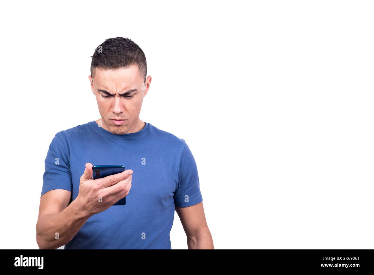 Man looking at the mobile phone with a serious expression Stock Photo