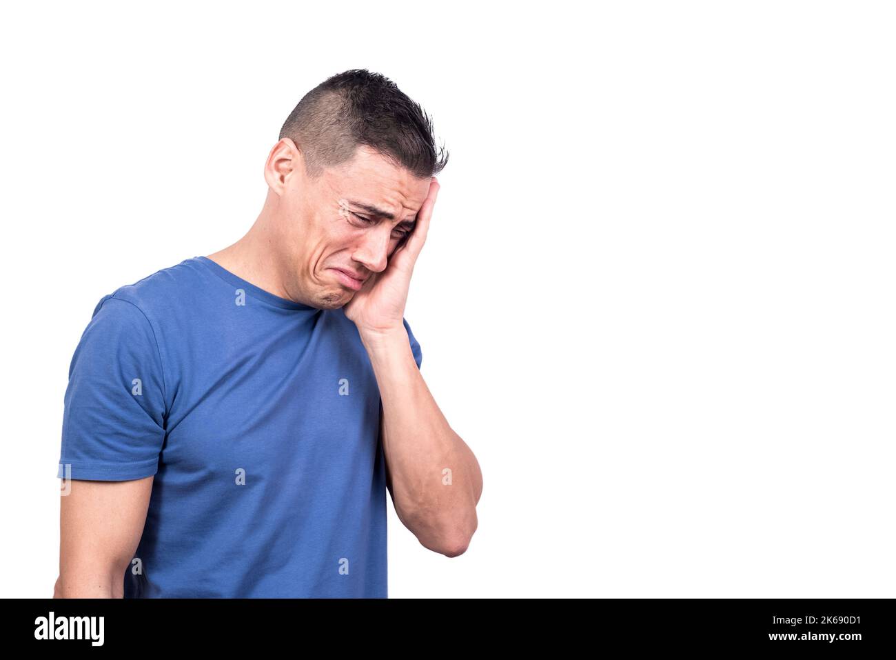 Sad man crying while touching the face with hand Stock Photo