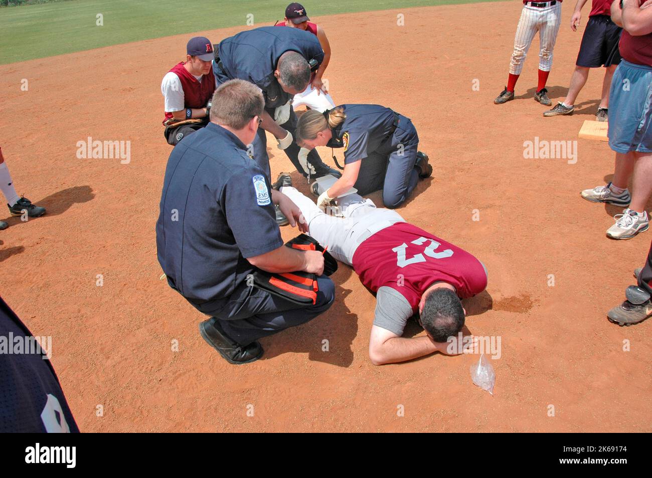 softball Player with broken leg is attended to by fire personal and