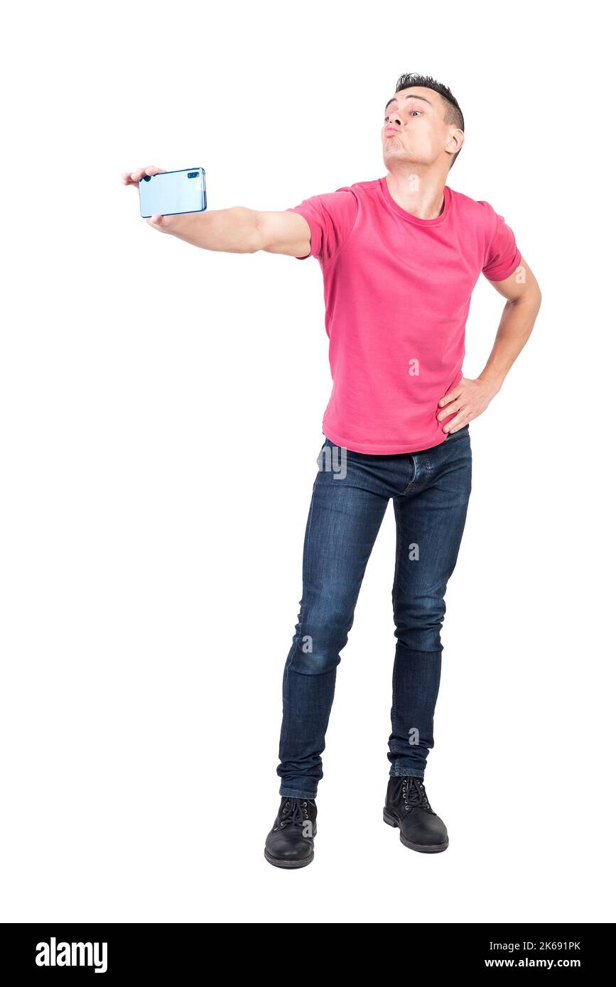 Joyful young male pouting lips and taking selfie against white background Stock Photo