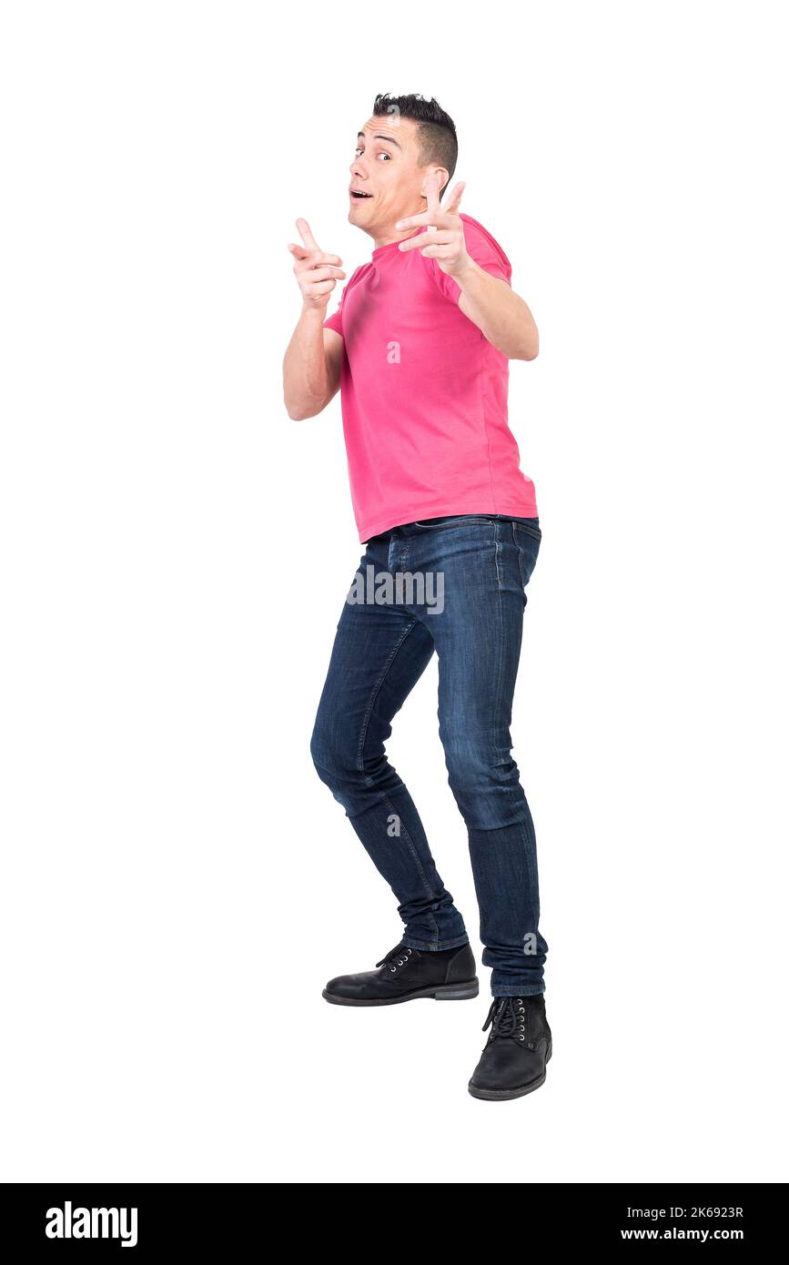 Cheerful young man pointing at camera in white studio Stock Photo