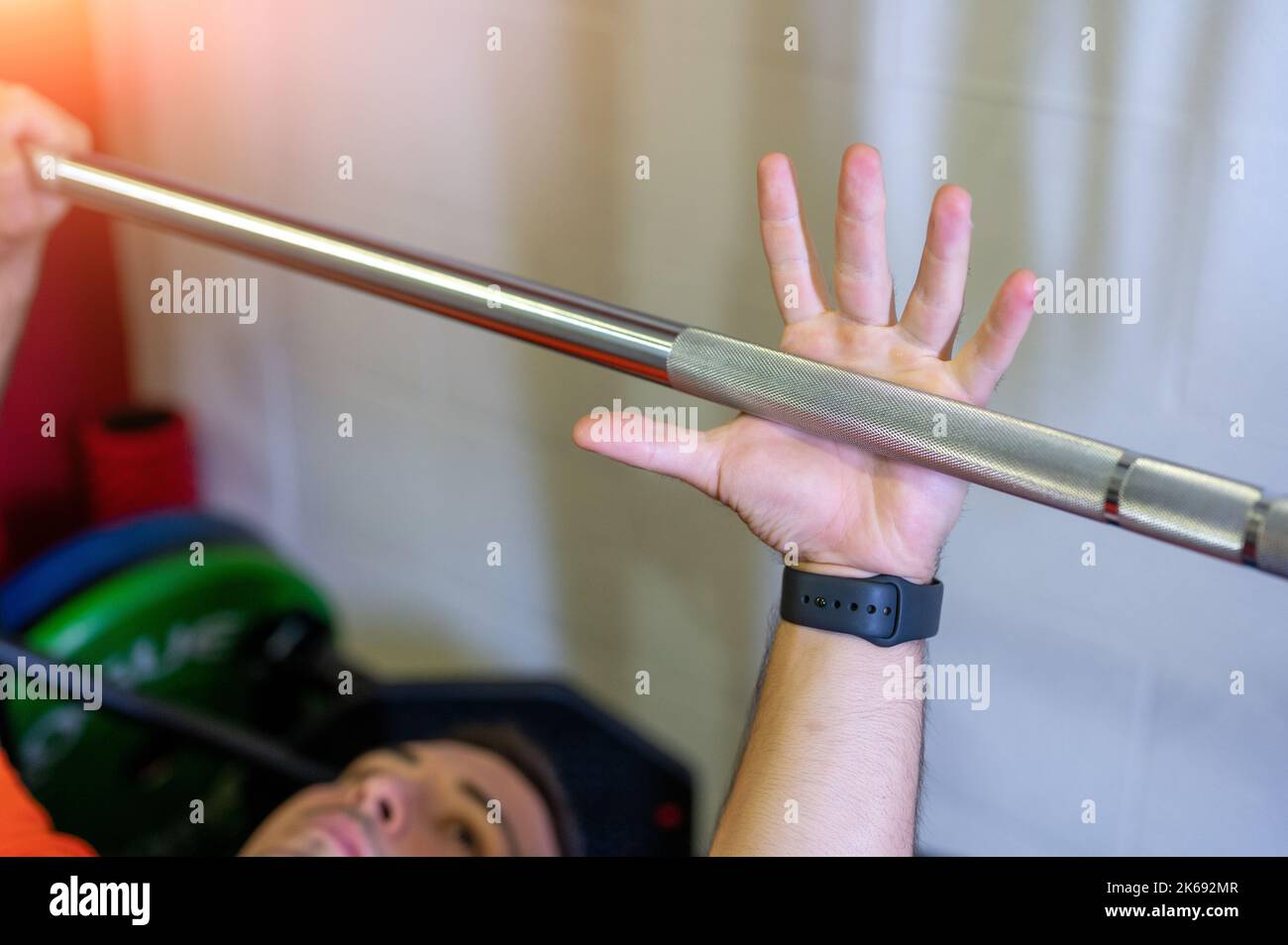 Conceptual image of hand grabbing the weight bar to start the bench