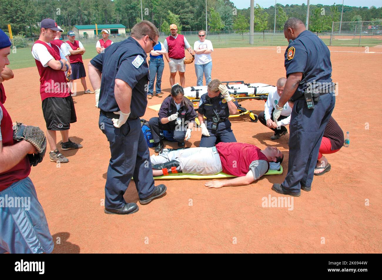 softball Player with broken leg is attended to by fire personal and