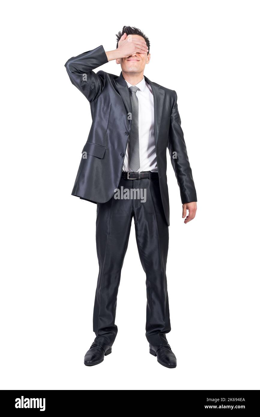 Businessman covering eyes in studio. White background. Stock Photo