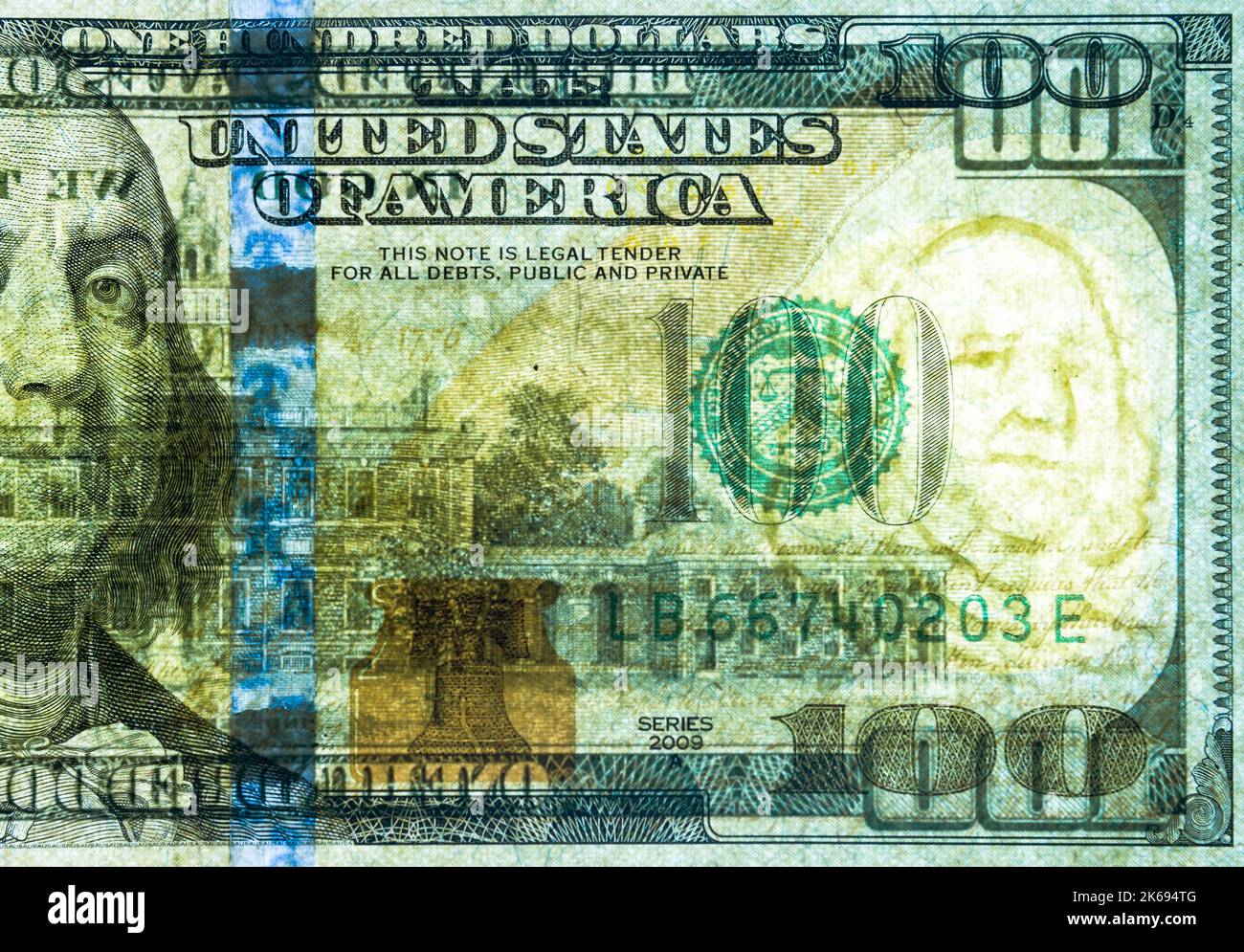 A United States of America 100 dollar bill has been backlit in order for the security watermark image portrait of Benjamin Franklin on the right to sh Stock Photo