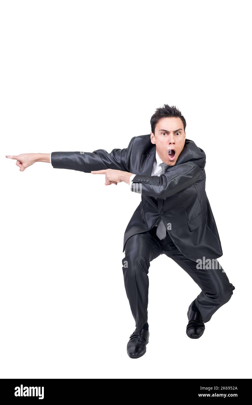 Amazed man pointing aside in studio. White background Stock Photo - Alamy